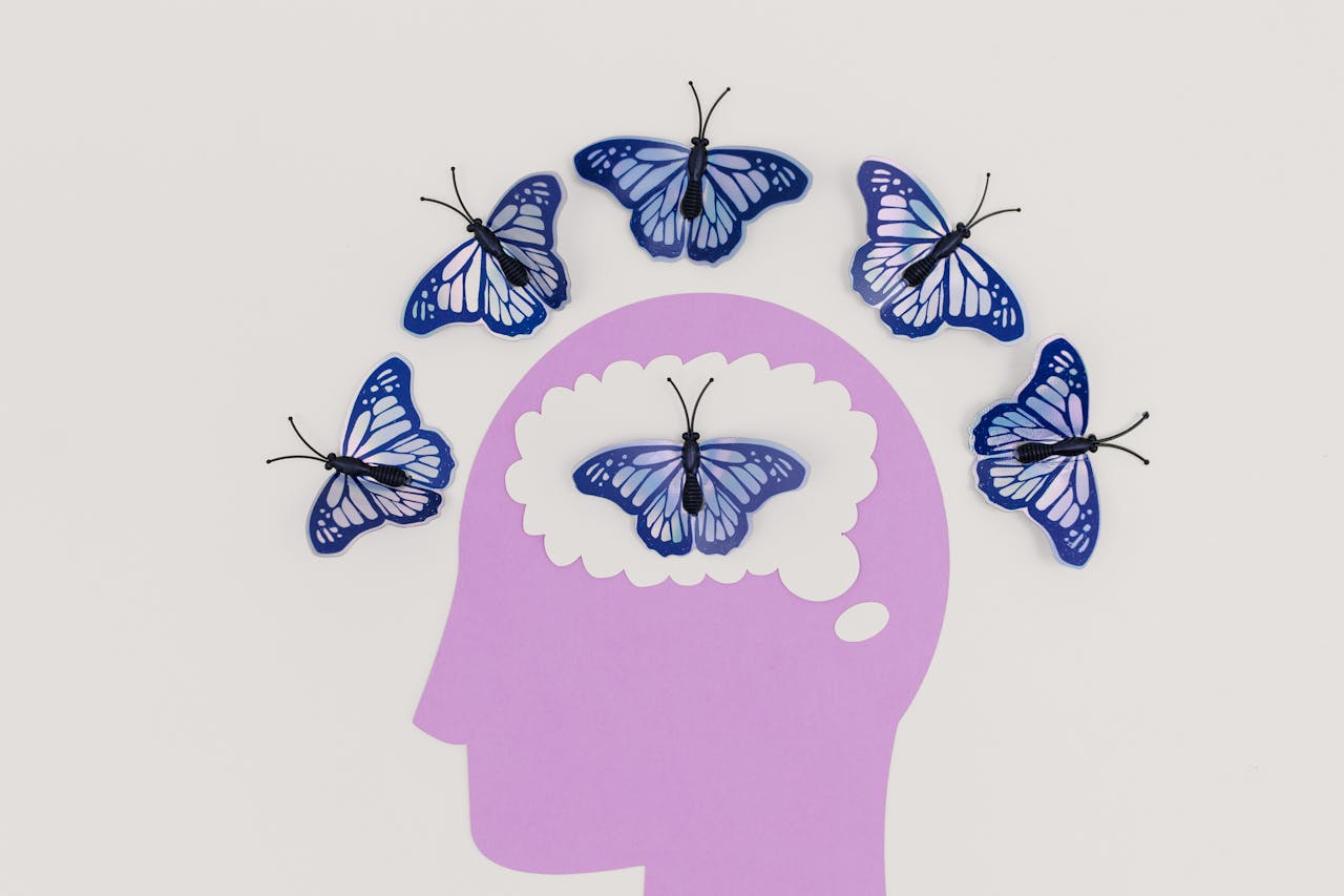 why-choose-us Creative illustration of butterflies representing thoughts over a brain silhouette.